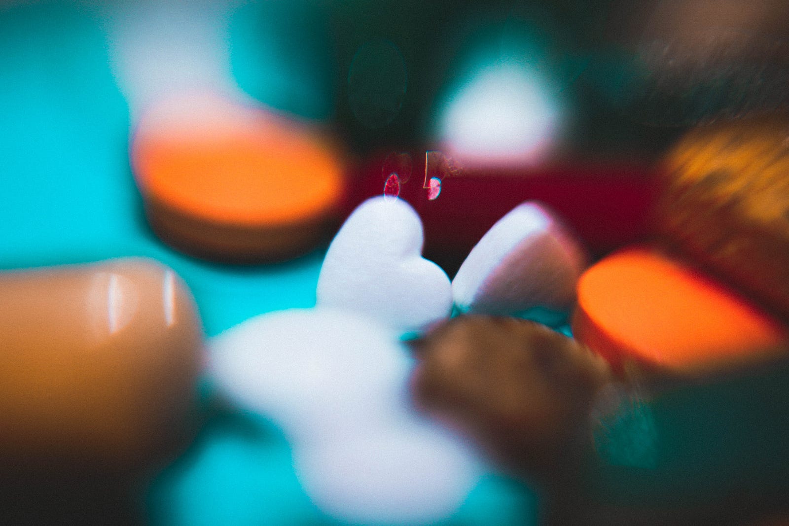 Pills of various shapes and colors, appearing blurry. Emerging evidence suggests that alterations in gut microbiota composition and function are associated with mood disorders. Probiotics help restore a healthy balance of gut bacteria, improving mental well-being.