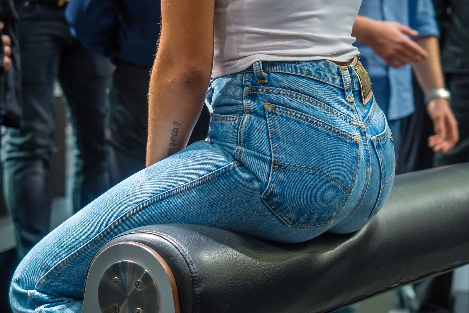 We see a woman sitting on a flexible green tube, knees to upper abdomen. Exercise has a dose-response relationship with visceral fat loss.