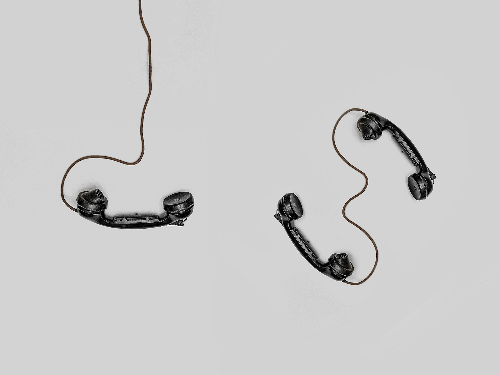 3 telephone headsets on a white background
