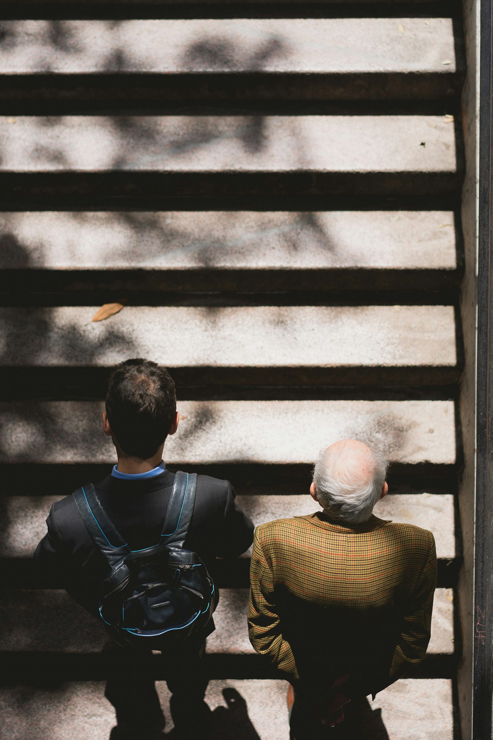 A younger and an older man walk up steps. Our protein needs increase with age.