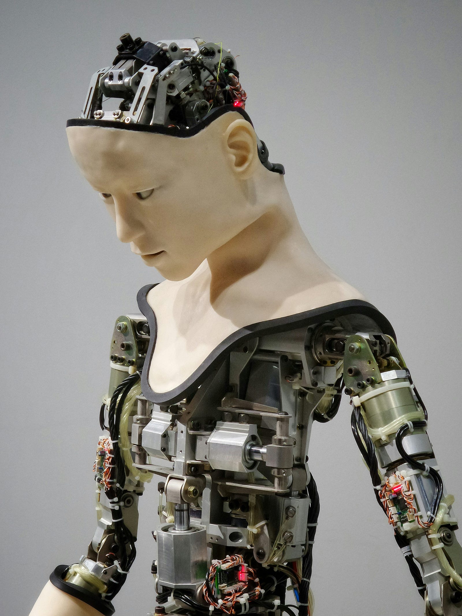 A robot, with the torso skin partially removed to reveal the mechanical innards.