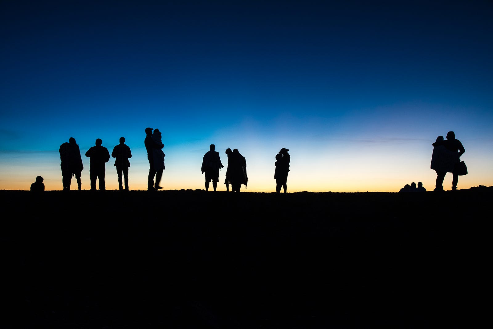 Several individuals in sihouette as the sun’s last rays rise in the background. Morning movement is a key ritual observed in the Blue Zones, world regions known for their extraordinary longevity and vitality. Light physical activity at the start of the day sets a positive tone for your body and mind.