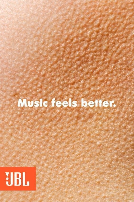 Goosebump on the background of white text that says “Music feels better” and a small JBL logo on the bottom left corner.
