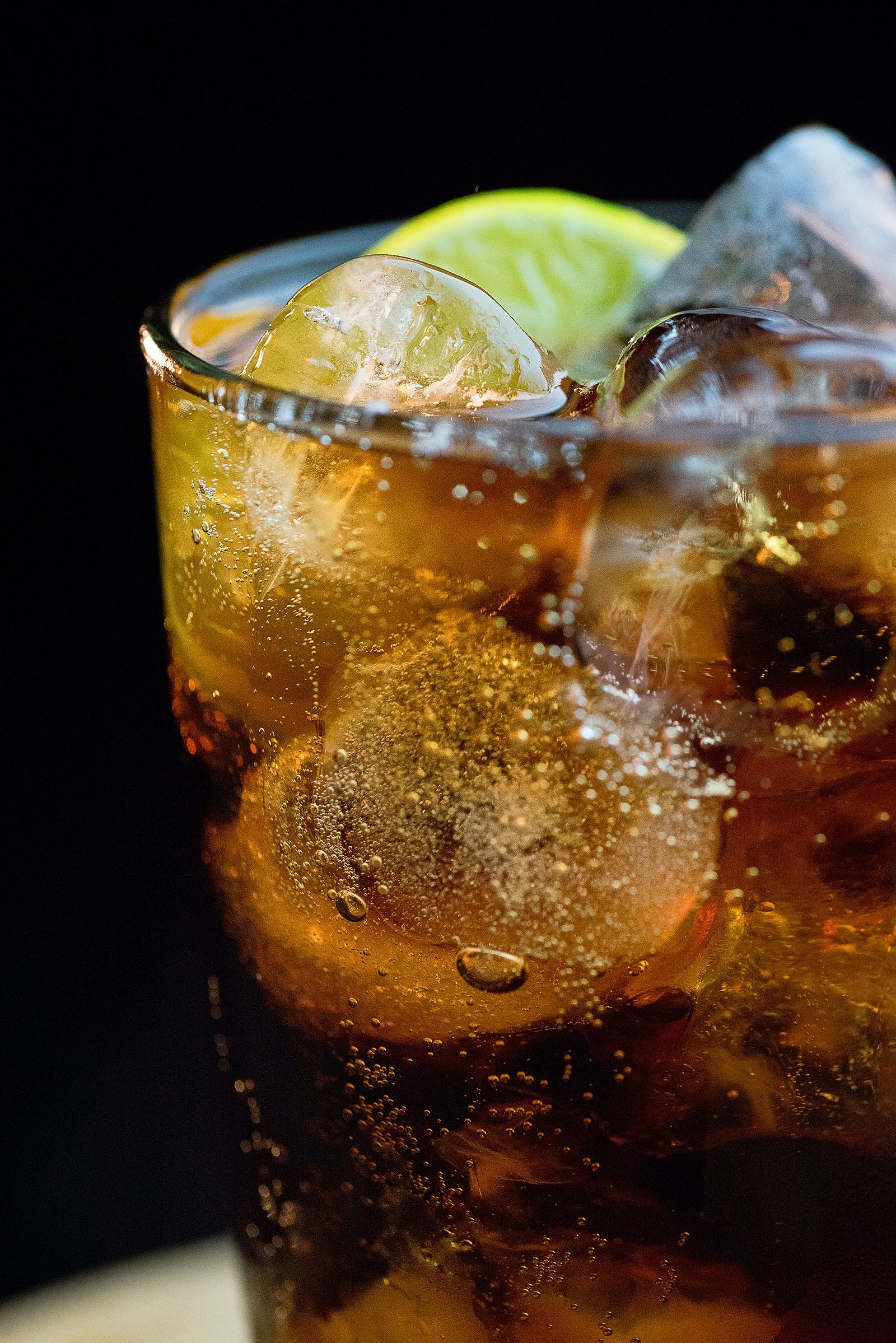A close-up photo of a glass of coke, with a lemon and ice. A large study led by researchers at the American Cancer Society (ACS) revealed some disturbing findings: Men and women who drank two or more servings of sugar-sweetened beverages daily — compared to people who never drank — had a five percent increased risk of death from obesity-related cancer, including gastrointestinal, postmenopausal breast, uterus, and kidney cancer.