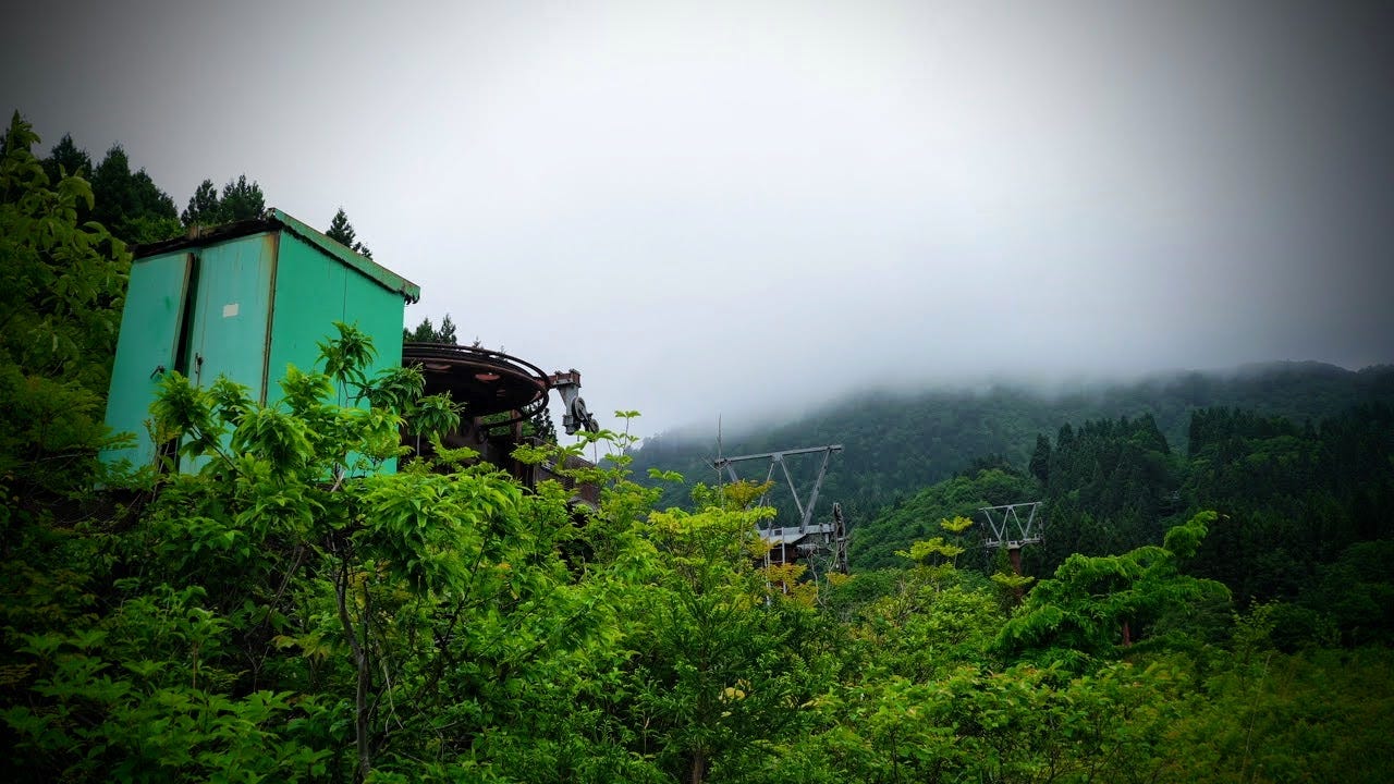 An abandoned ski lift on Tsuchiyu-yama in the northern Japan prefecture of Yamagata under a cloudy mountaintop.