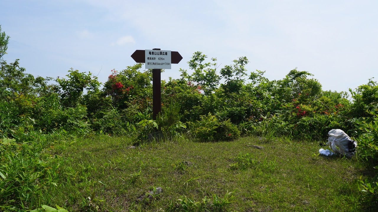 A sign in a clearing at the de facto summit of Kamewari-yama points to the real summit of Kamewari-yama