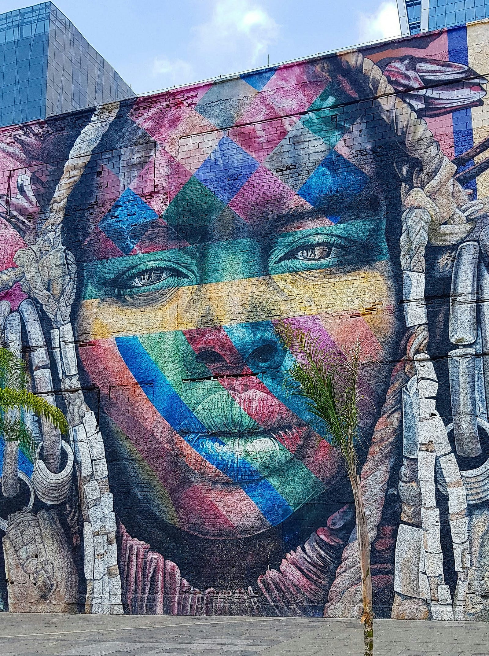 A colorful mural of a young woman of color in Brazil.