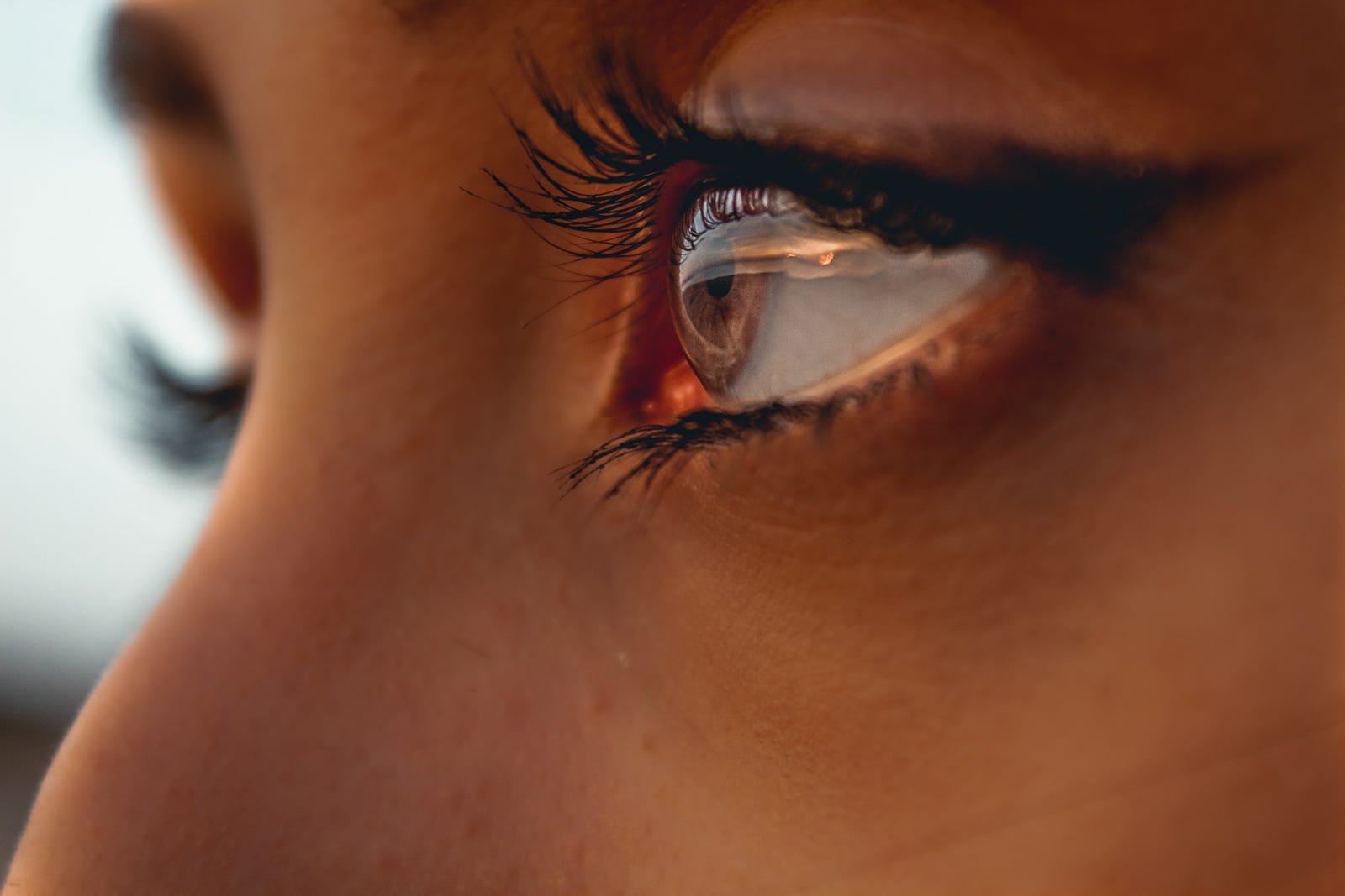 Close-up of a woman’s face (upper nods and left eye) in profile. Not having good contact lens hygiene increases the risk of serious eye infections. Serious eye infections that can lead to blindness affect up to one out of every 500 contact lens users annually.