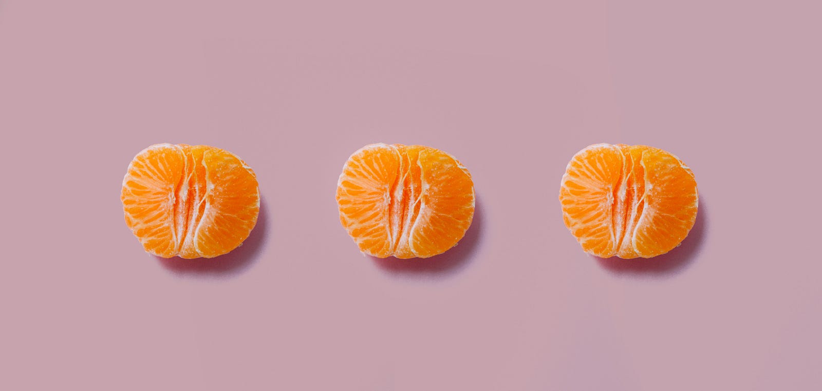 Three tangerines (peeled), horizontally aligned.