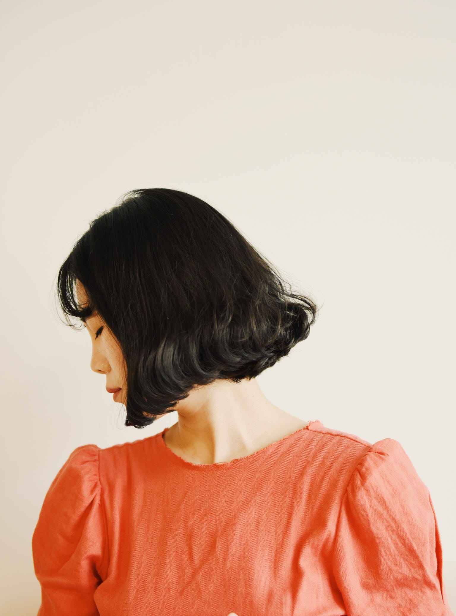 A young Asian women in profile, eyes closed, tips her head down to the left. She dons an orange shirt. Antibiotics are often the treatment for UTIs. Recurrent infection is at least three events within one year (or two or more occurrences within six months). The same microbe that caused previous infections is usually responsible for recurrences.