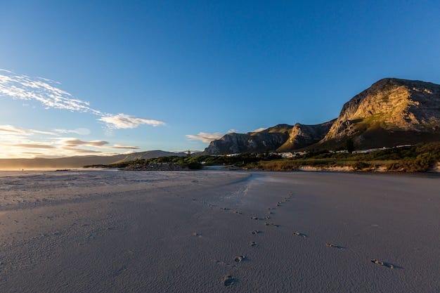 Chasing the sunrise on a quiet beach — footprints in the sand, mountains in the backdrop, and endless morning vibes.