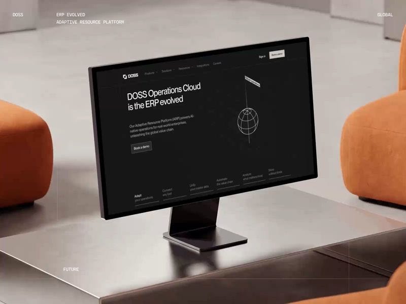 Minimal workspace scene featuring a desktop screen displaying a dark ERP platform interface with clean layout and enterprise-focused design.