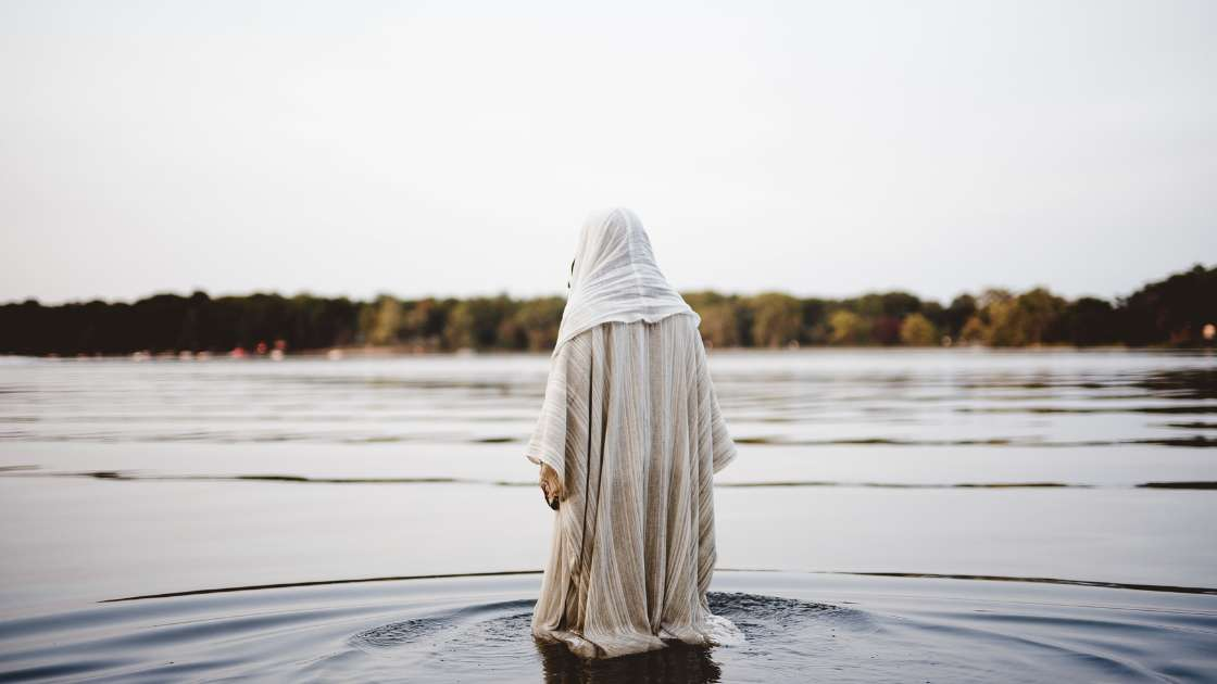 Man portraying Christ stepping in the water