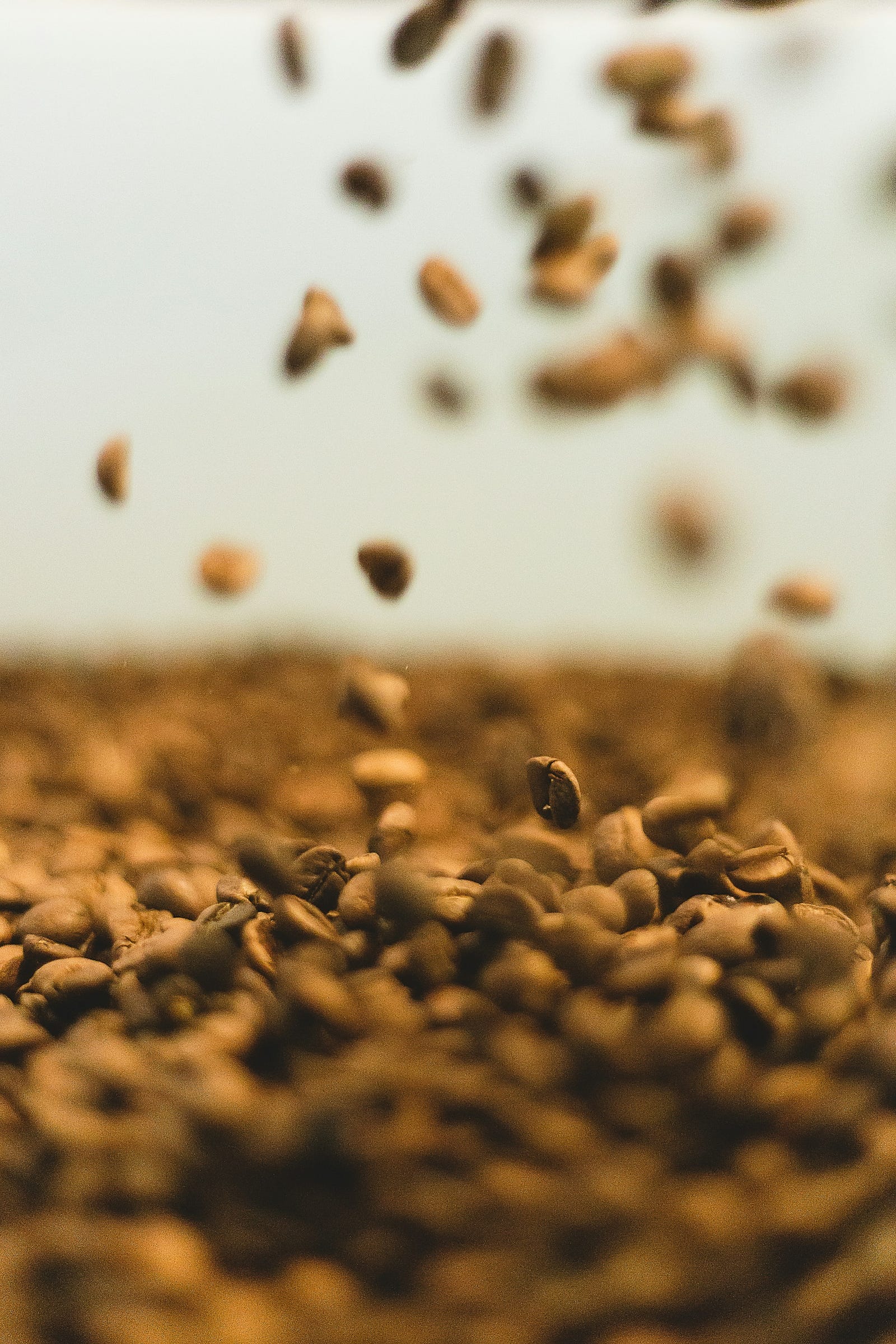 Coffee beans drop from above.