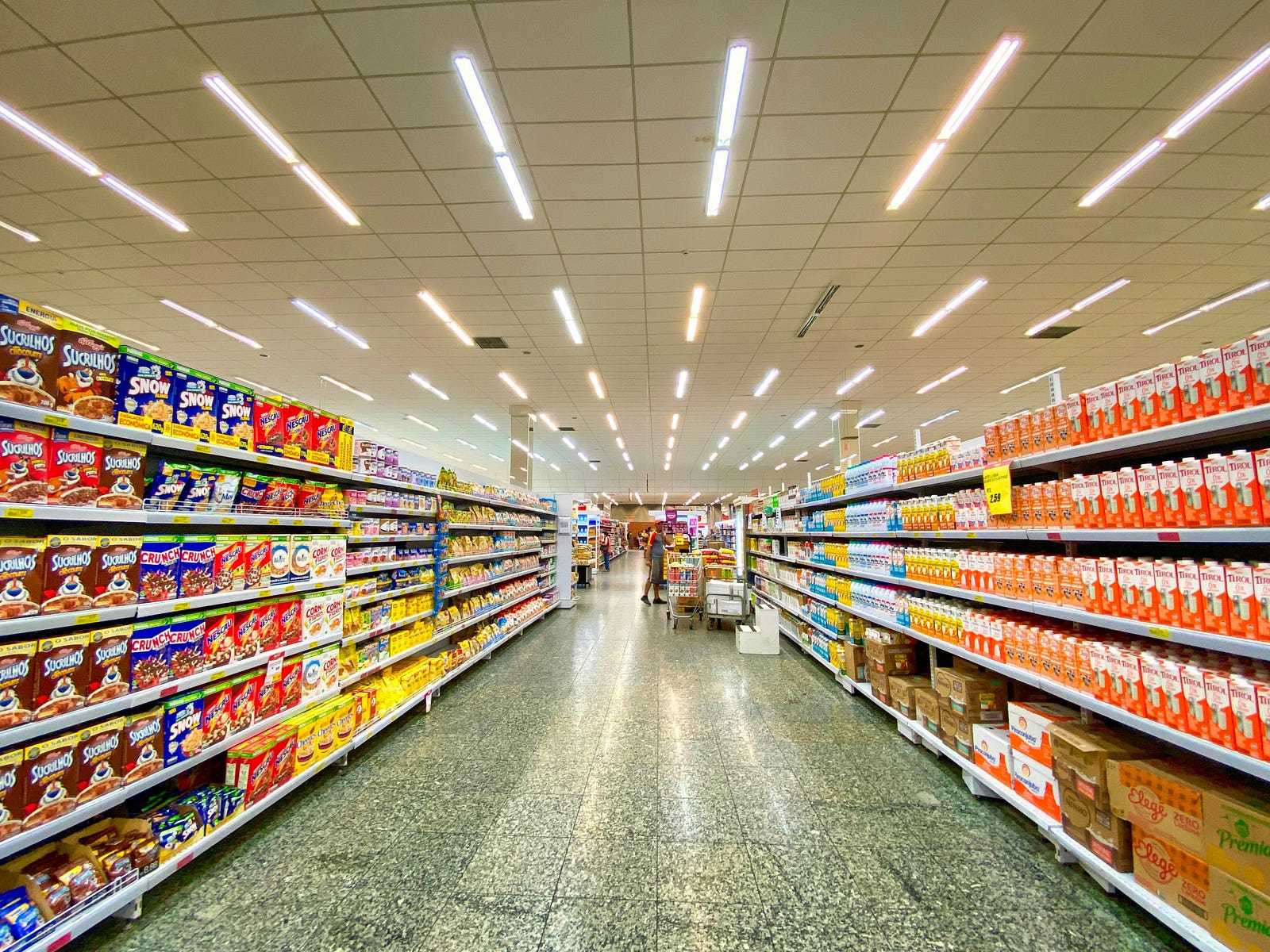 A single aisle of a grocery store, its shelves chock full of ultra-processed foods.