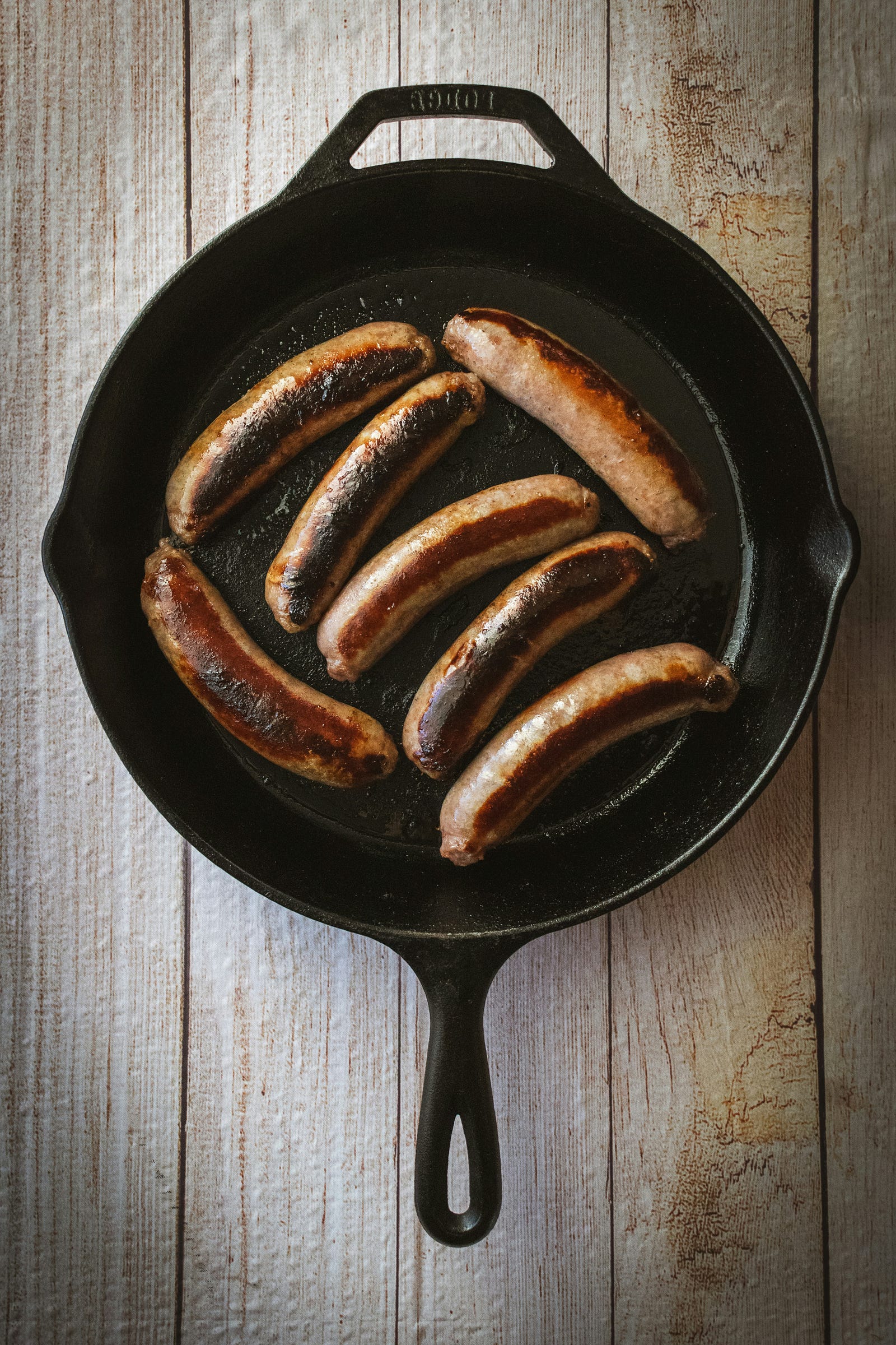 Sausage in a pan. Hot dogs and sausages are generally highly-processed foods.