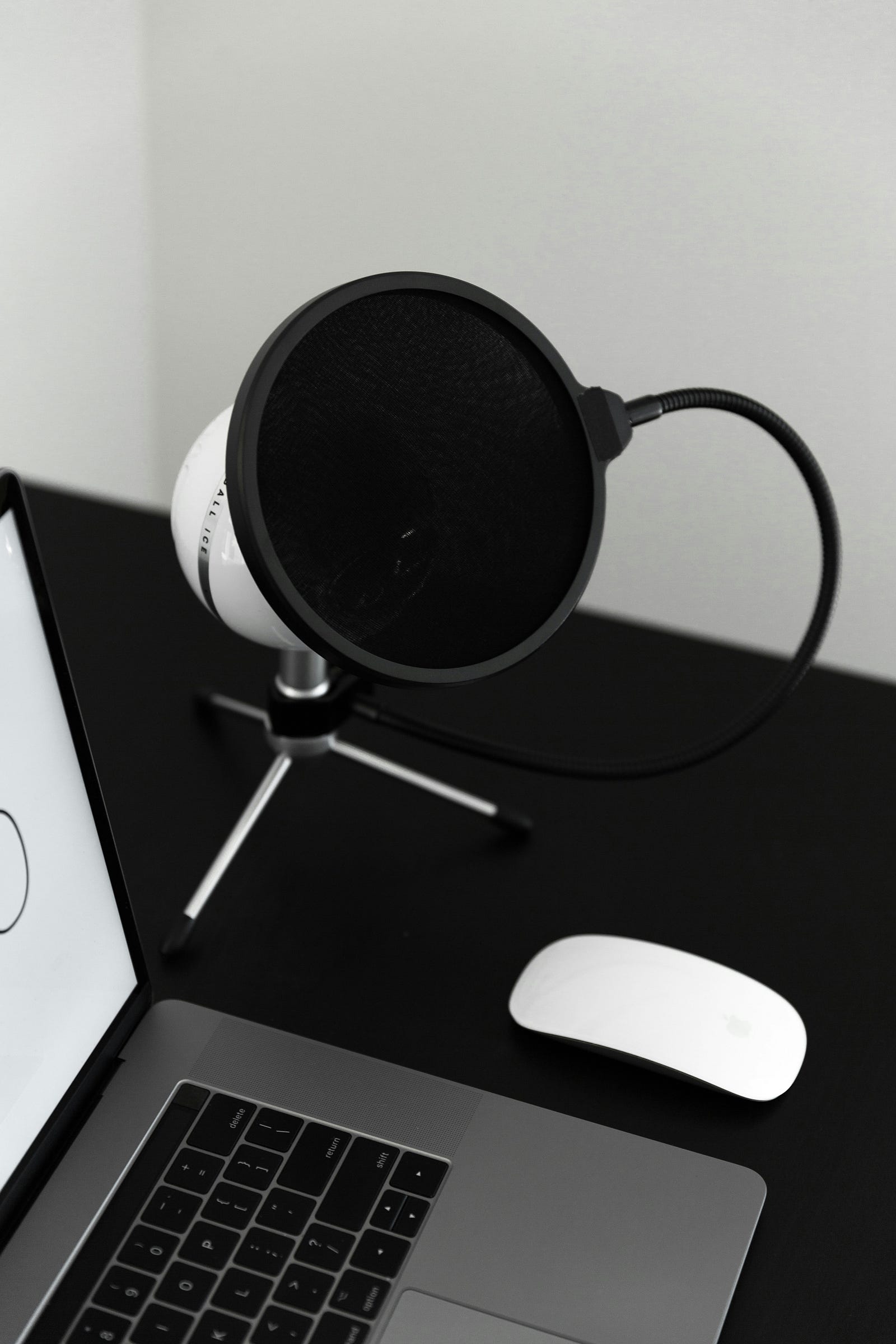 A computer with a speaker next to it. Apple AirPod Pro devices can serve as hearing aids.