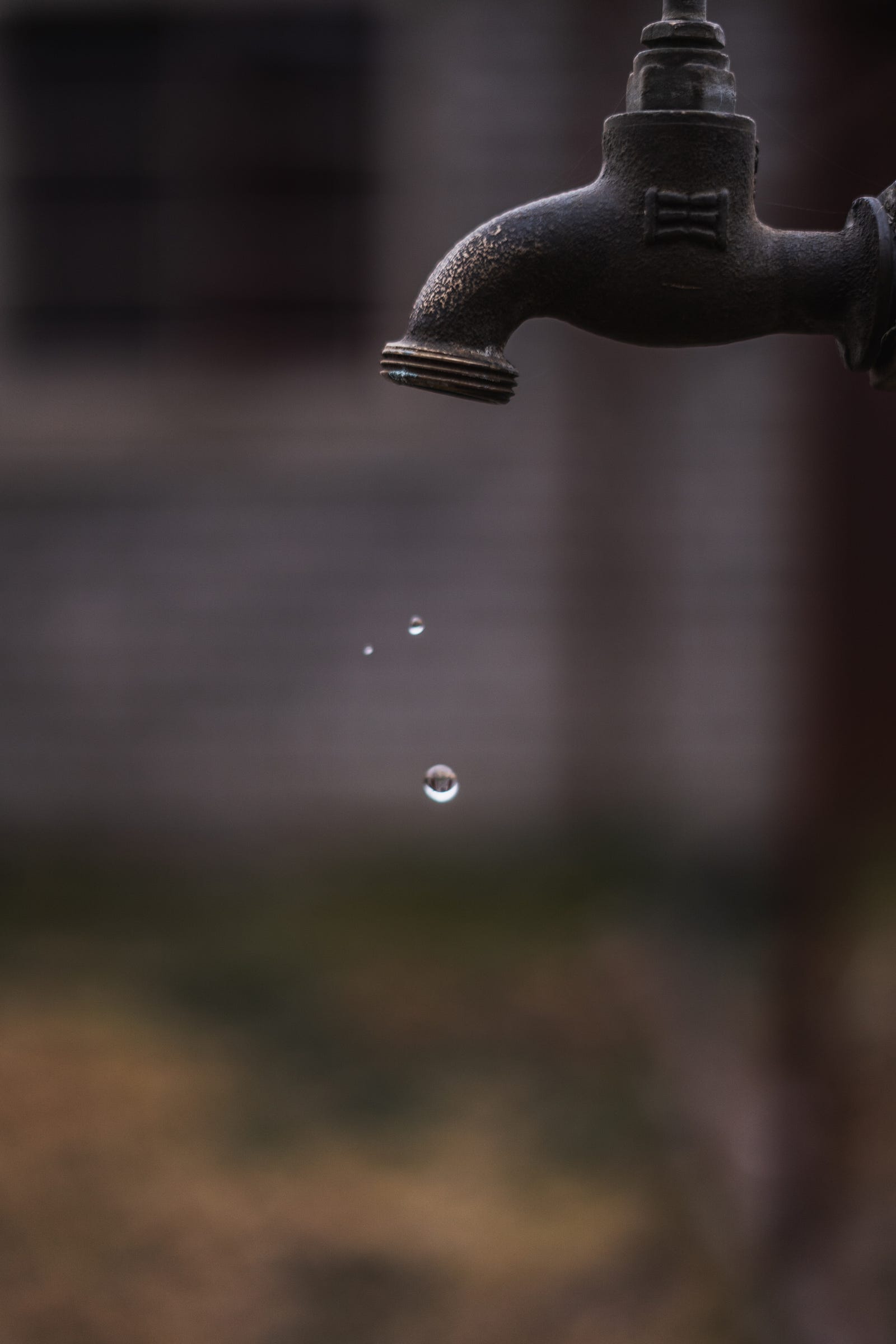 An outside faucet drips water. In recent years, there has been growing concern about the health risks of PFAS.