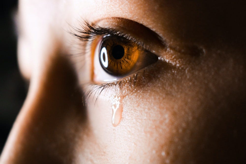 woman shedding a tear