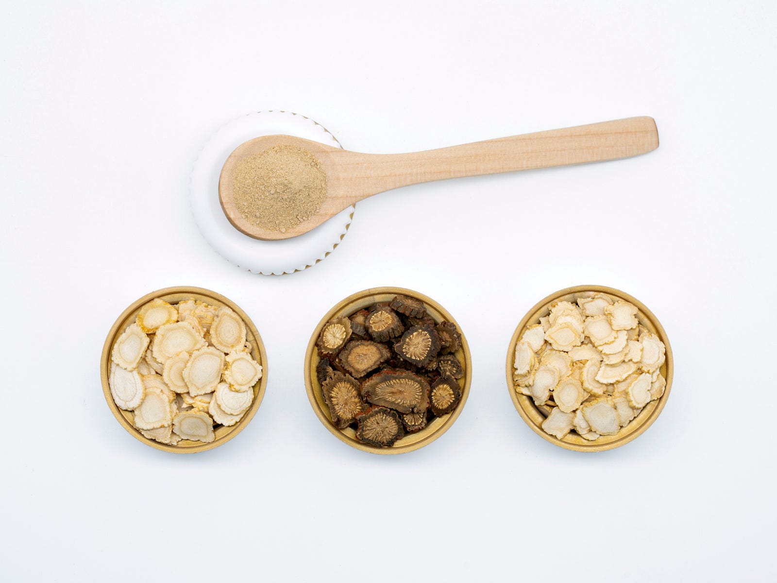 Three small bowls filled with supplements.