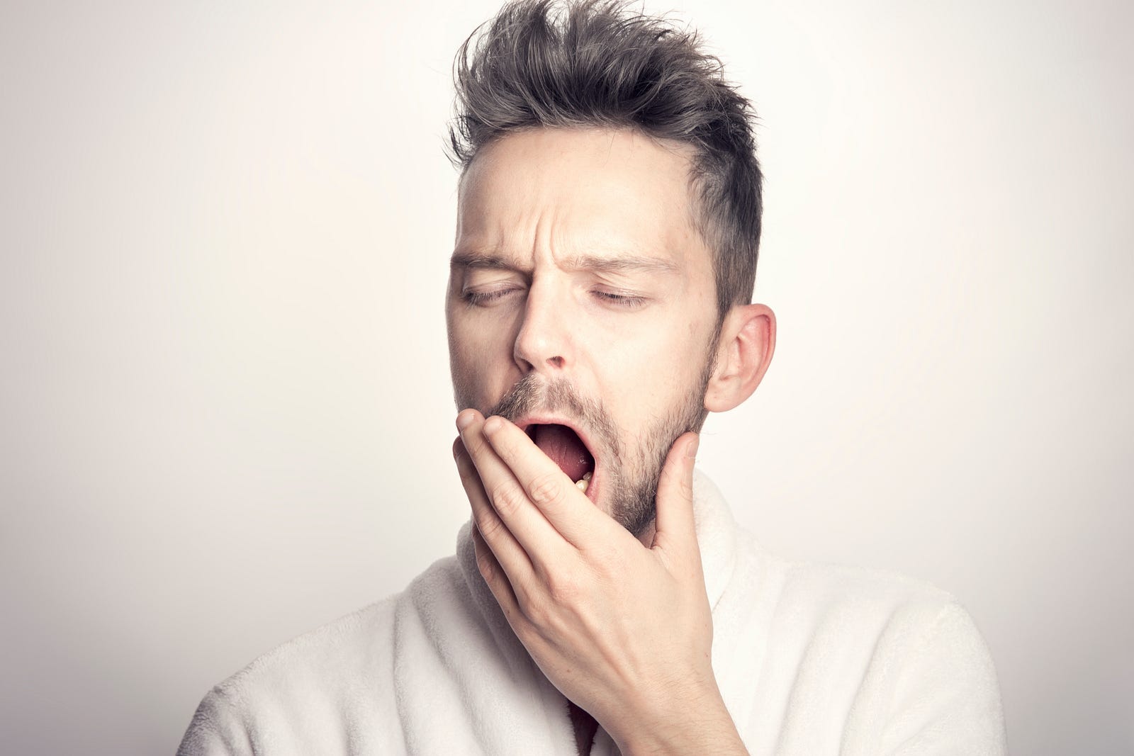 A young man yawns, covering his open mouth with his left hand. Insomnia:  Melatonin might reduce the time it takes to fall asleep, but its effects on sleep quality and total sleep time aren’t clear. Older melatonin-deficient adults might get benefit from insomnia.