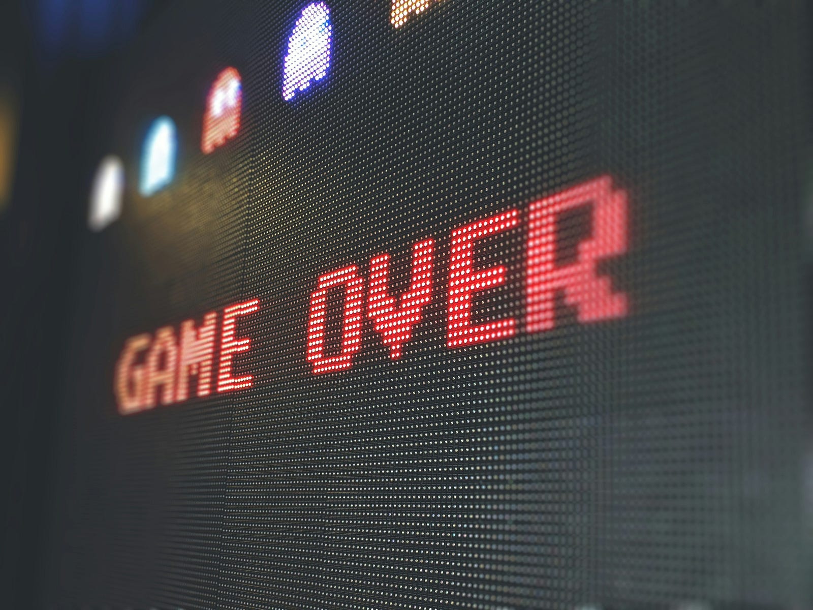 A PacMan screen reads “GAME OVER” in red letters.