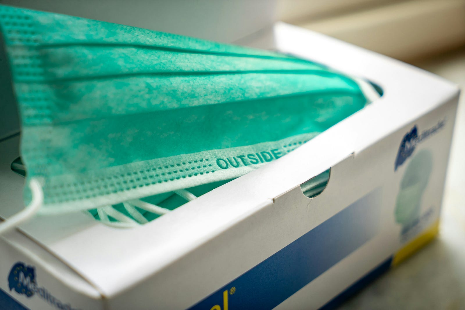 A box of paper surgical masks.