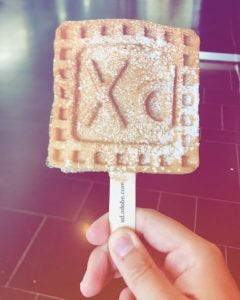Picture of my humble hand holding a wonderful waffle featuring the Adobe Xd logo