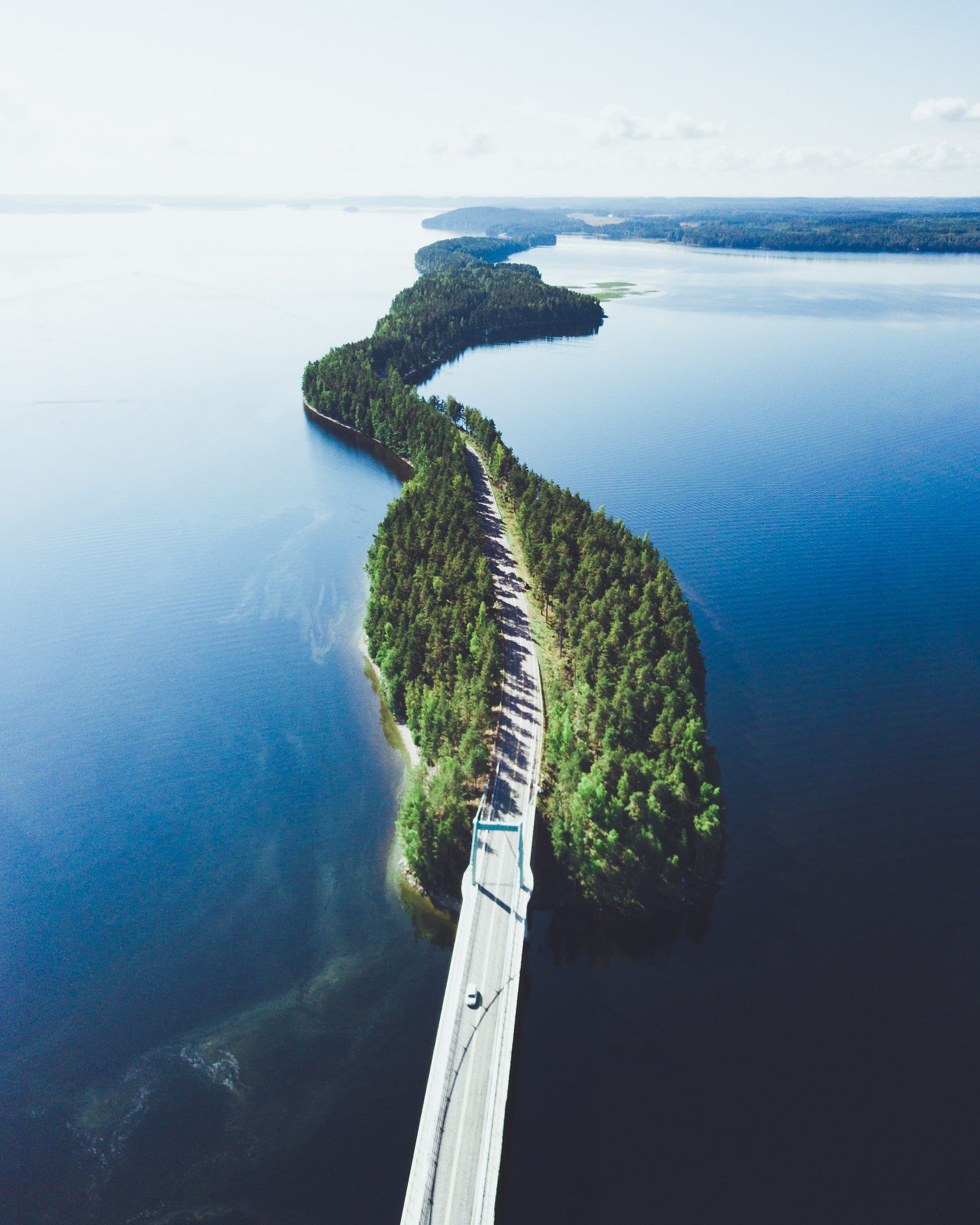 A stunning road in Finland meanders across a large lake, with the road having narrow wooded areas on either side. A new Finnish study shows that being more physically active was linked to a lower risk of dying from various causes.