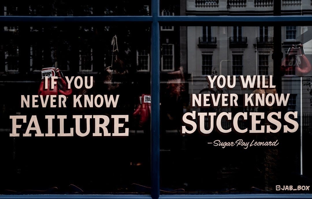a window with a quote saying "if you never know failure, you will never know success"
