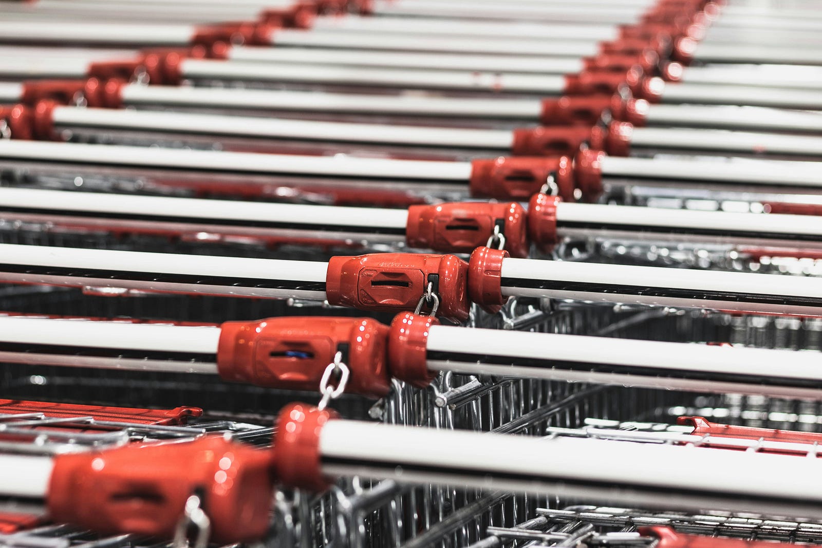 Two rows of silver-colored shopping cards (with red tips on their handles) seen in close-up. Simple hygiene practices can go a long way. Consider using sanitizing wipes provided by the store, or carry your own to give the handle a quick wipe before diving into your shopping spree. It’s a small effort that can significantly reduce your exposure to harmful bacteria from shopping carts.