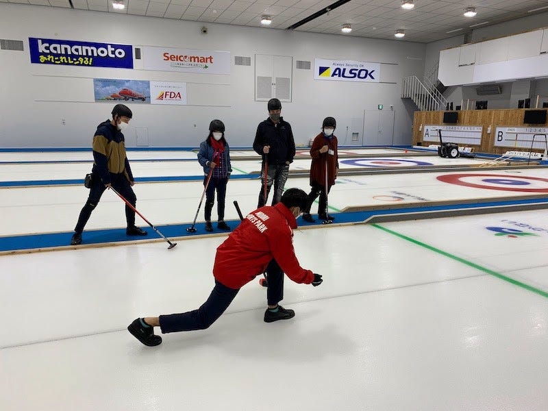 Donny Kimball learns curling from a pro at Wakkanai’s Midori Sports Park in northern Hokkaido