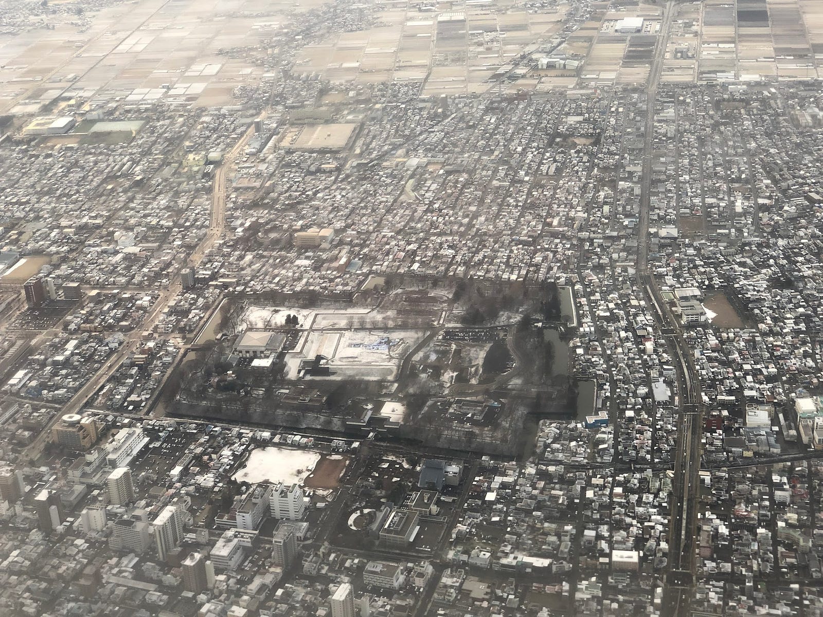 Yamagata Castle seen from the sky in winter, a dark grey rectangular complex.