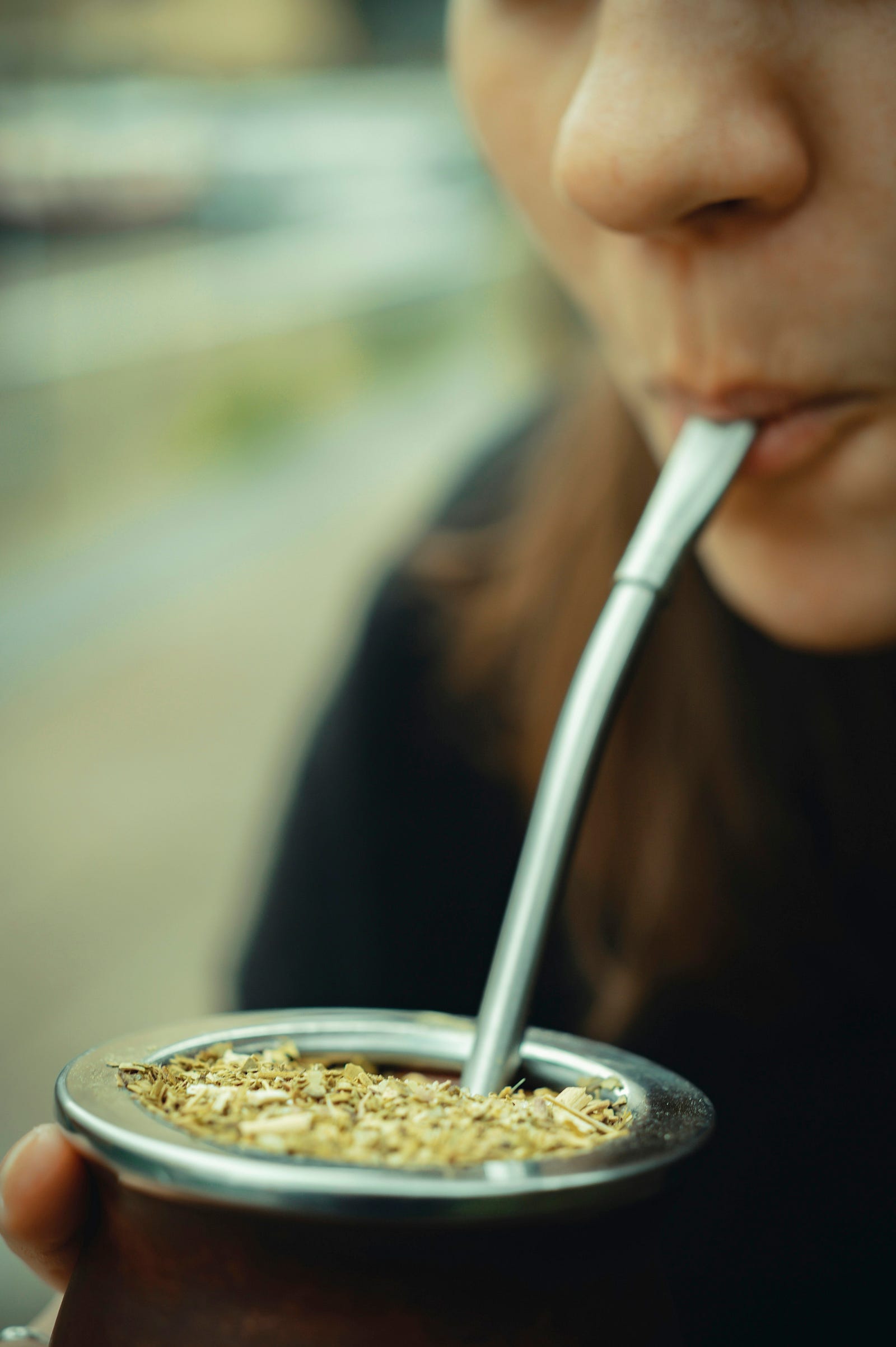 A woman sips on a cup of mate. The high temperatures of the beverage may increase cancer risk.