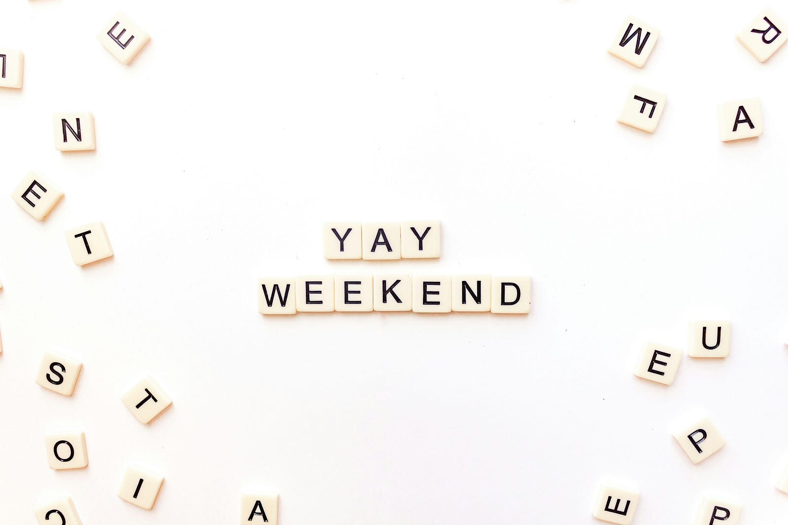 Scrabble tiles spell out “YAY WEEKEND.”