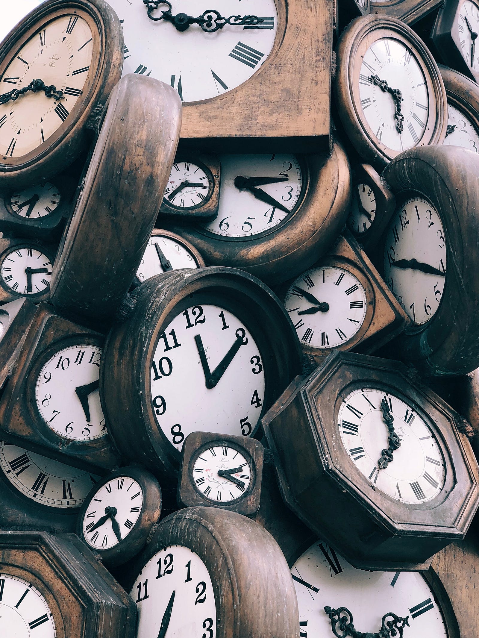 A dozen old wooden clocks sit in a pile. One small study discovered this: Sleep-deprived young men had high levels of the appetite-stimulating hormone ghrelin and lower levels of the satiety-inducing hormone leptin.