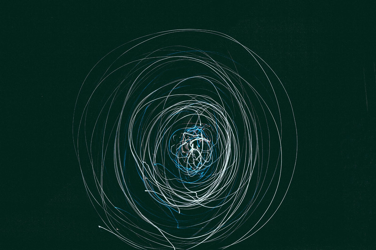 A thin string wraps around creates orbits around a more dense tangle. There is a black background. In a recent study published in Nature Chemical Biology, researchers employed AI techniques to discover a potent antibiotic capable of tackling superbugs. The researchers could generate and screen millions of virtual molecules by training their AI model on a vast dataset of bacterial structures, known drug compounds, and their interactions.