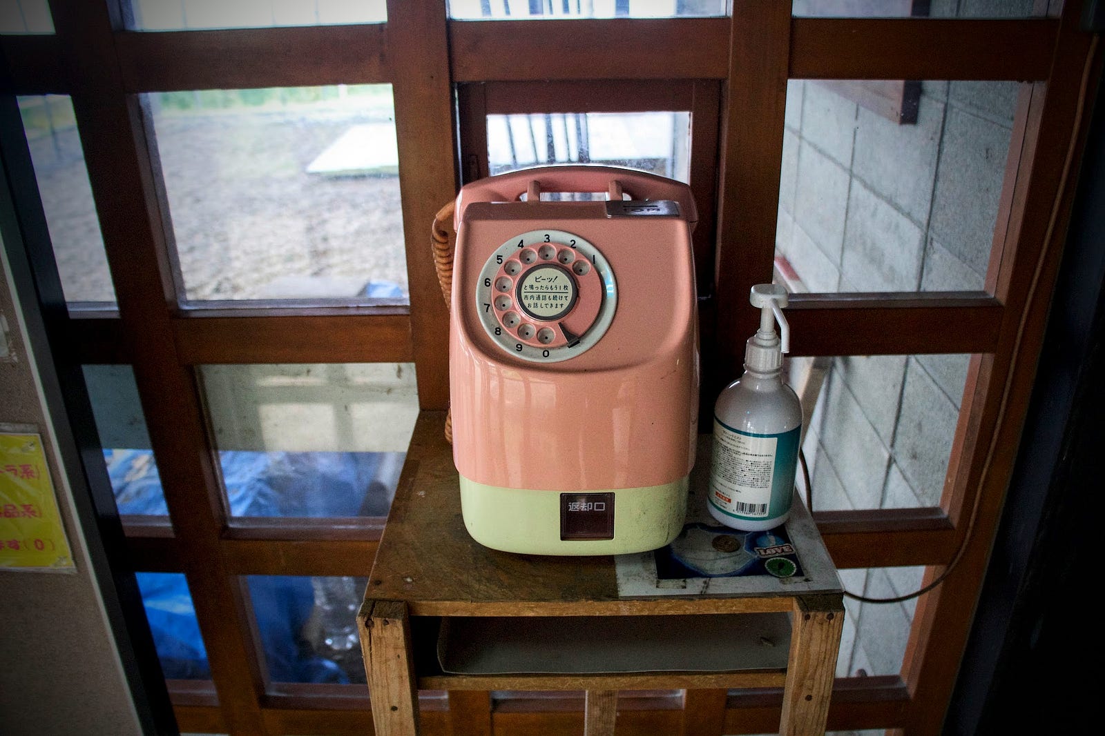 A pink and white phone sits in the corridor of Hayama Shimin-so