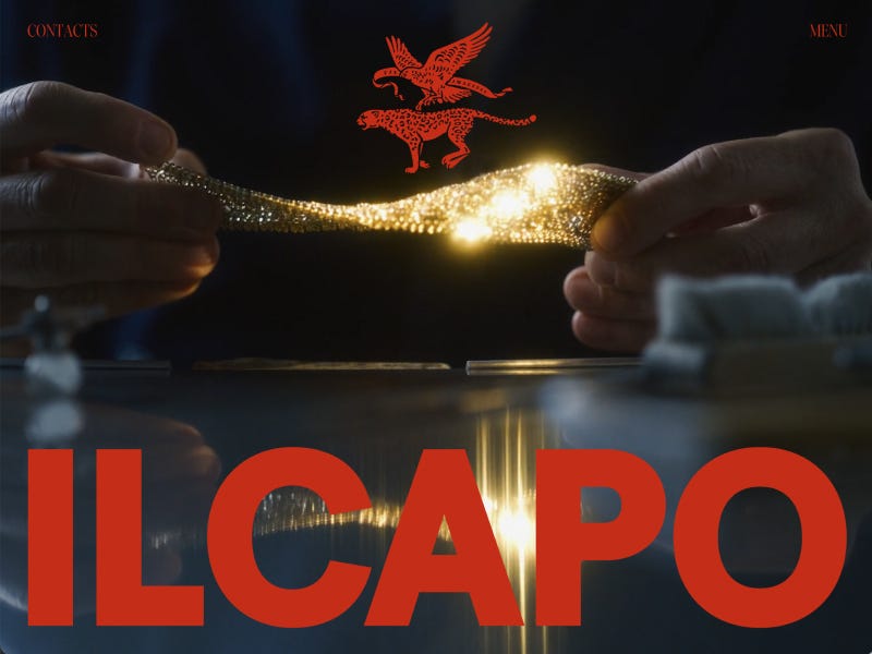 Dark cinematic homepage for Il Capo Production featuring hands stretching a glowing metallic material, dramatic reflections, and oversized bold red typography over a luxury industrial visual aesthetic.