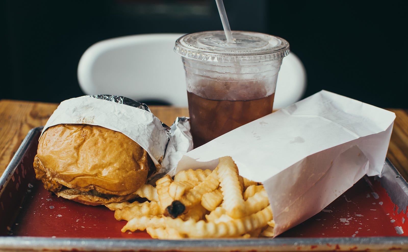 A hamburger and krinkle fries (spilling out of a small white bag). A plastic cup of coke is in the background. In type 2 diabetes, the body either doesn’t produce enough insulin or becomes resistant to the effects of insulin. Insulin is a hormone produced by the pancreas that helps regulate the absorption of glucose (sugar) into the body’s cells for energy use. When there is a lack of insulin, or the body’s cells do not respond properly, glucose builds up in the bloodstream.