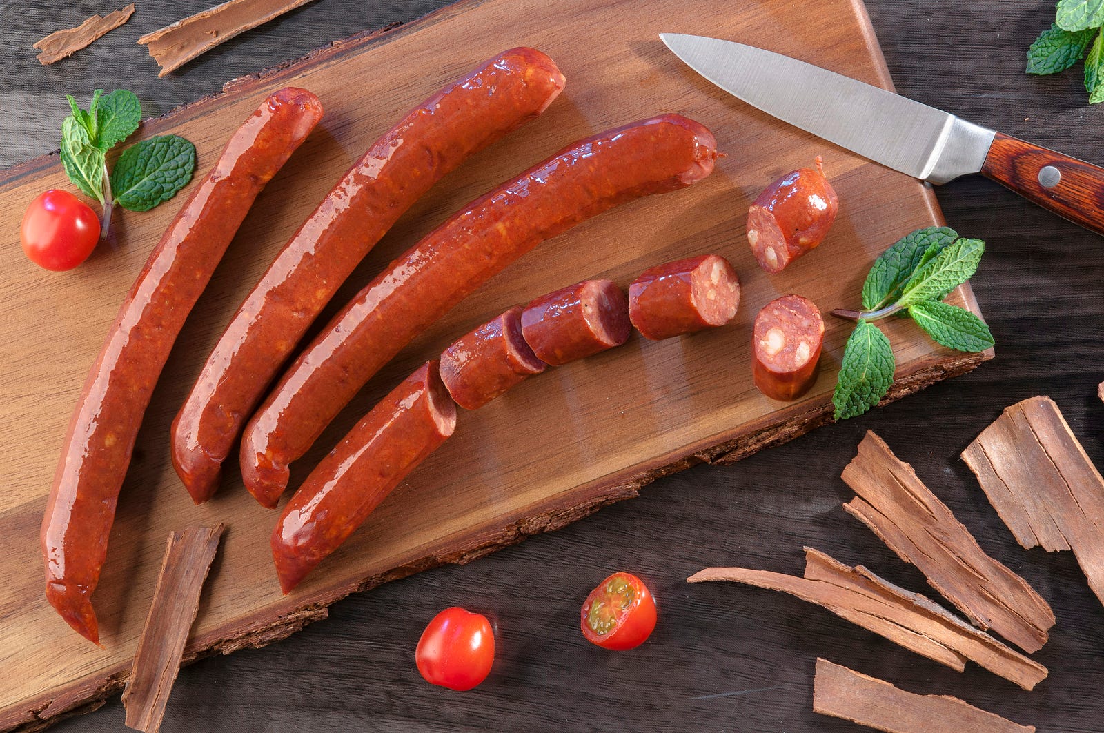 Sausages on a wooden board. Processed foods may increase colorectal cancer risk.