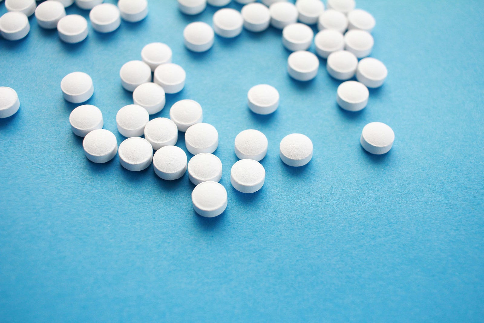 Numerous white pills. Hormones (such as estrogen and progesterone in combination) can increase breast cancer risk.