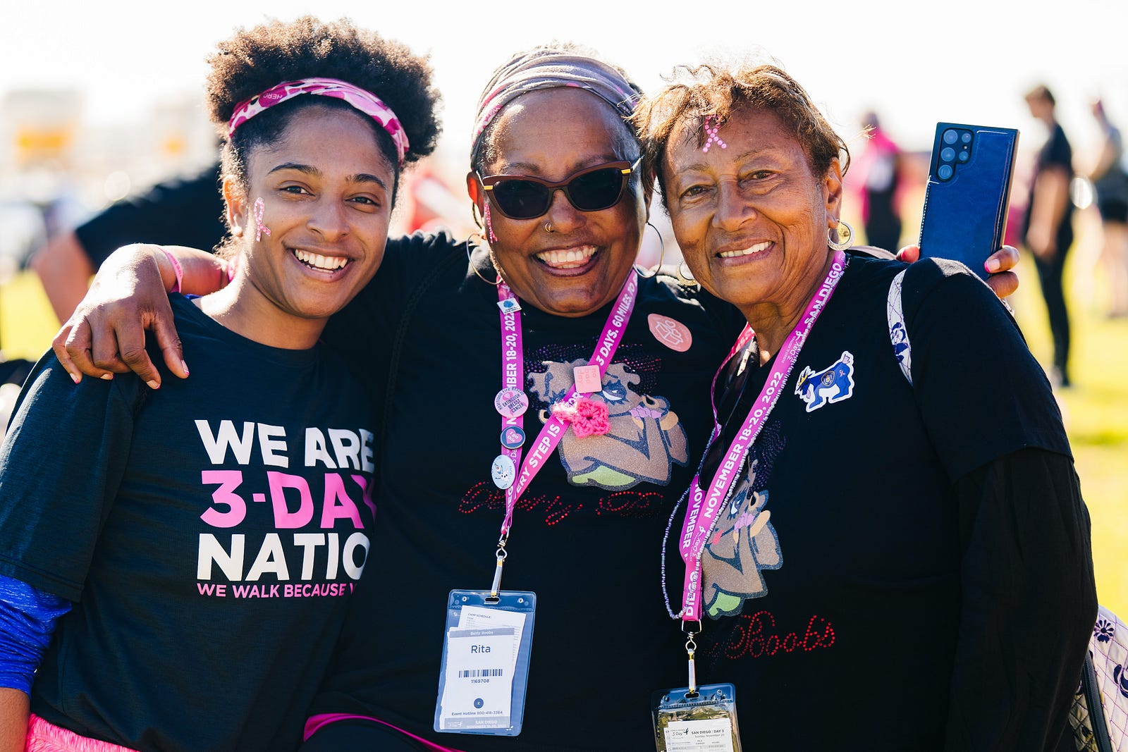 Three black women smile as they wear Susan G. Komen 3-Day Nation T-shirts. Breast cancer risk-raising genetic mutations were similarly prevalent among U.S. Black and Hispanic white women.
