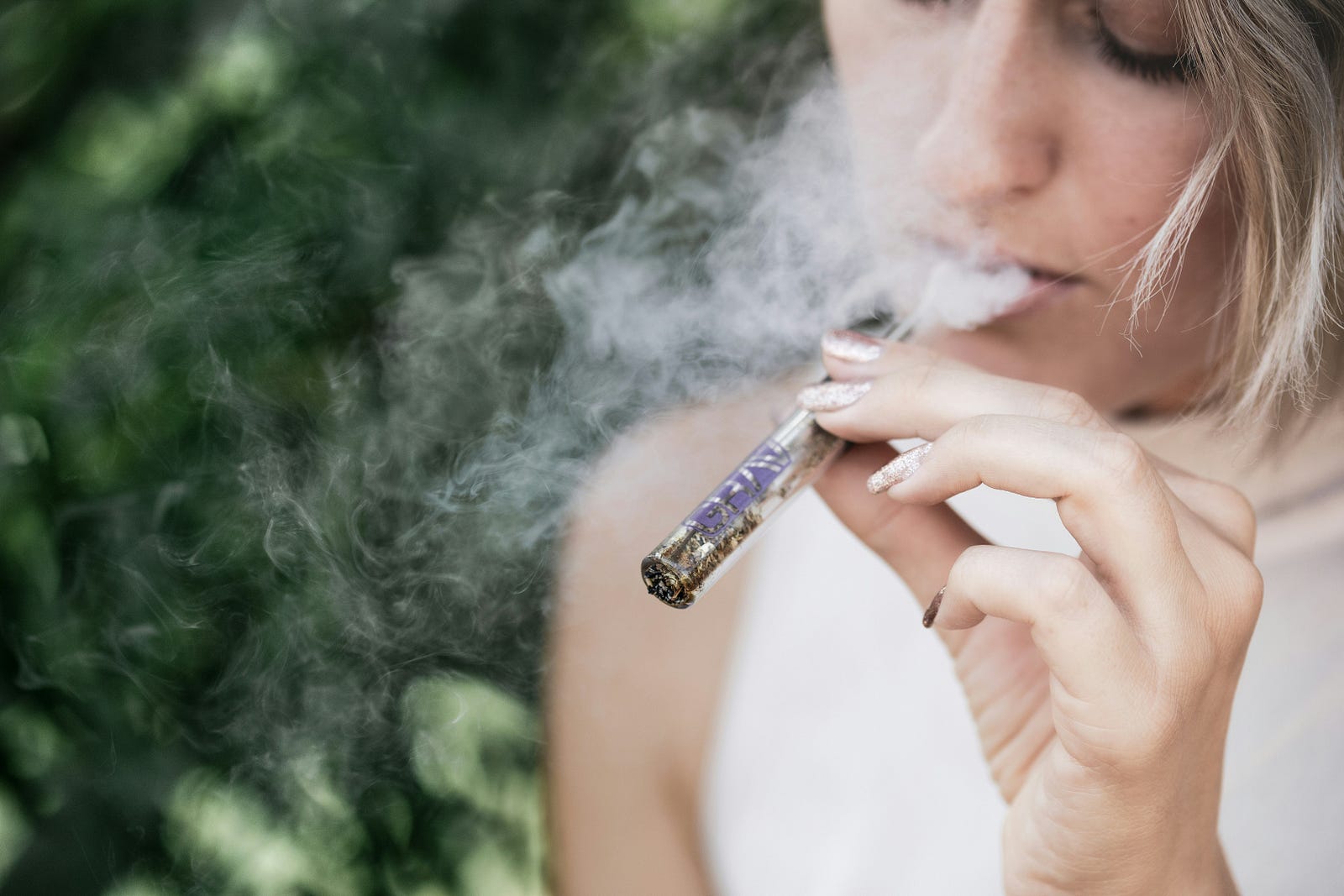 A woman smokes pot.