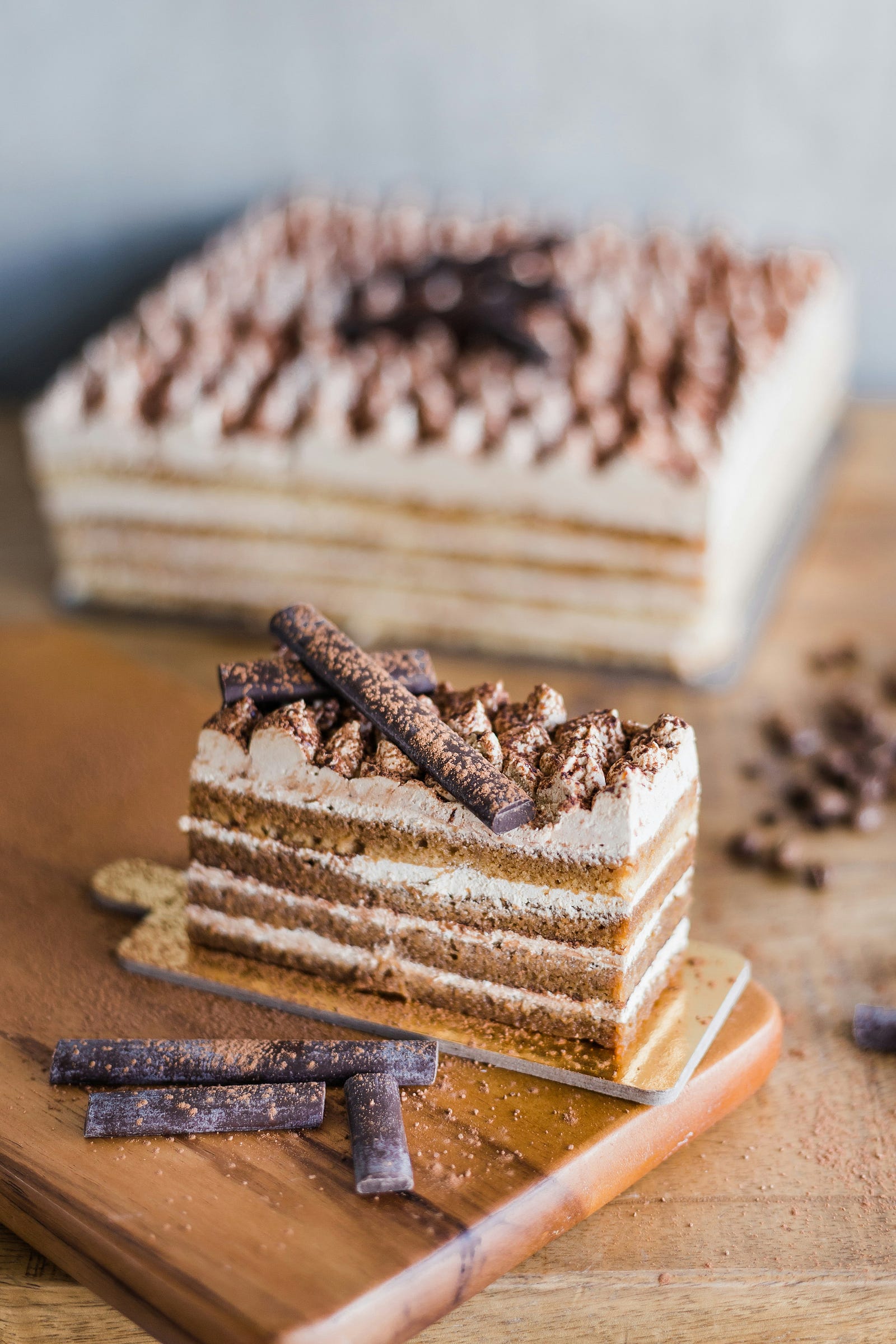Multilayered carrot cake, with a cylinder of chocolate atop it. Make cakse are highly processed.