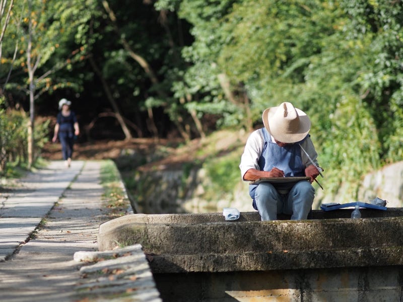 A man works on some artwork along the Philosopher’s Path in Kyoto during the pandemic