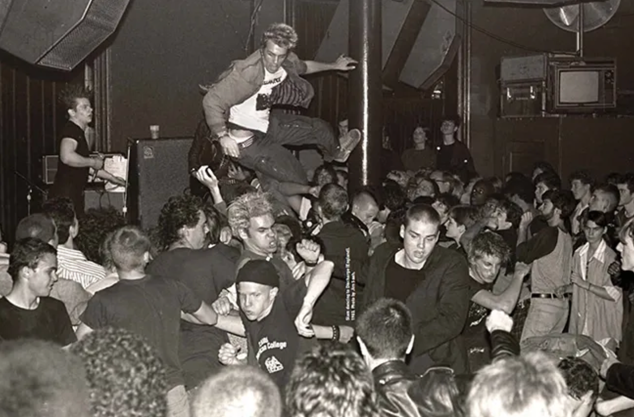 A black and white photo featuring a packed venue full of people dancing.