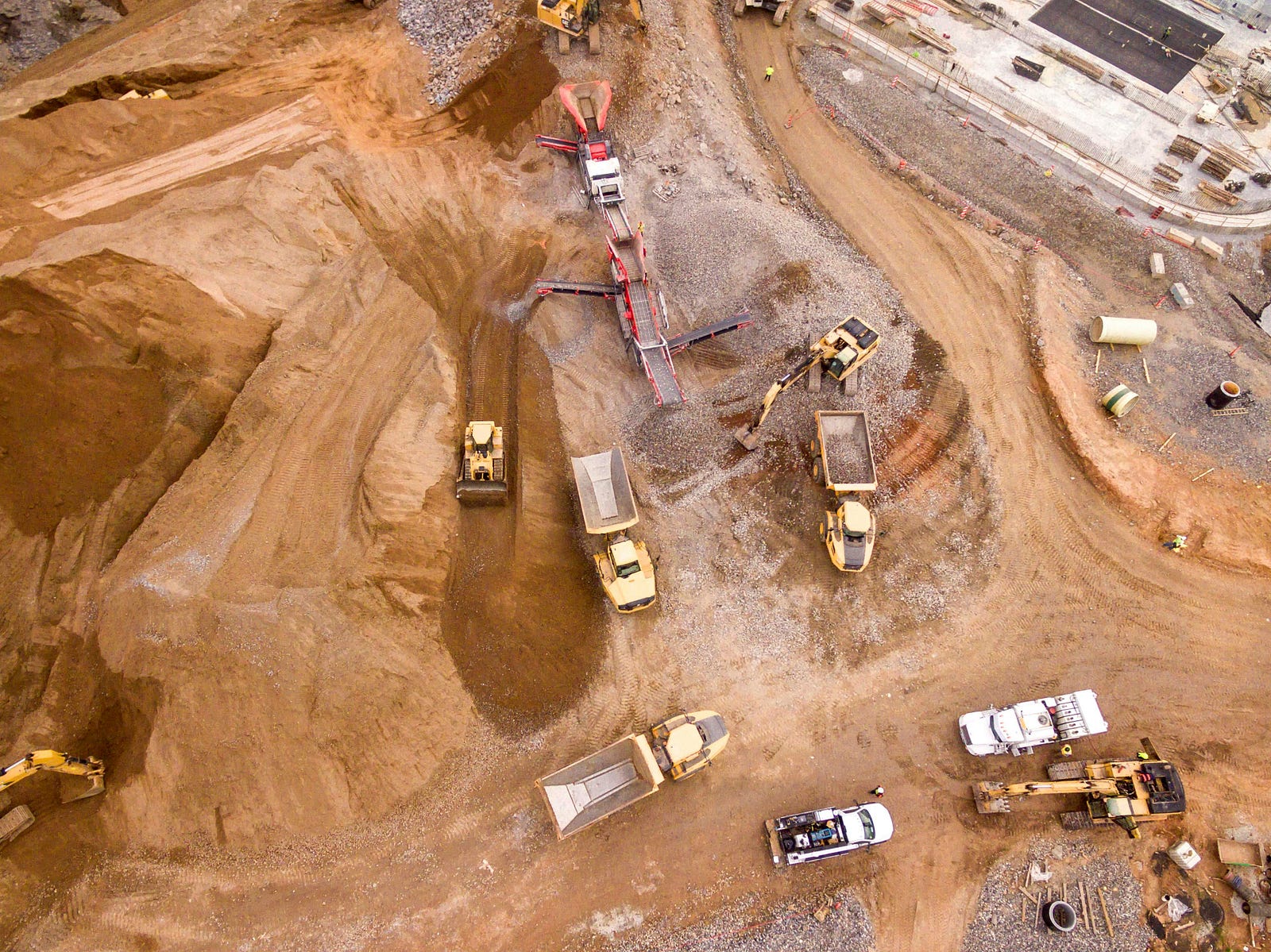 Open-pit mining site, showing the environmental impact of resource extraction and capitalism’s drive for growth.