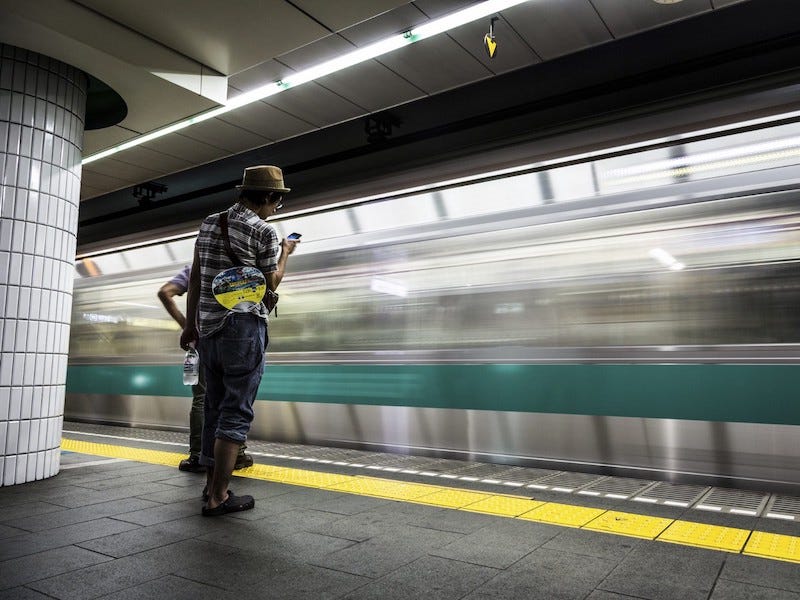 A subway train rushes by a station in Tokyo.