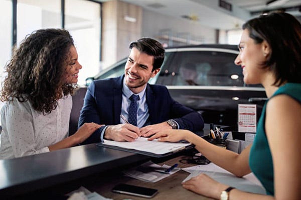 where to buy car title usa car title and vehicle registration paperwork being completed at DMV during vehicle purchase